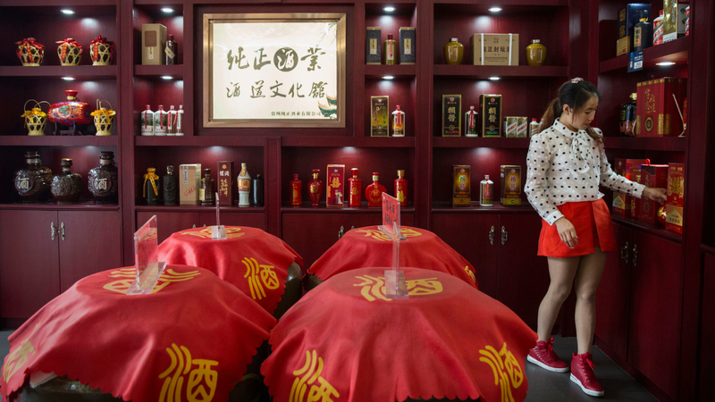 A woman works in a shop selling locally made baijiu in Maotai in China’s Guizhou province.
